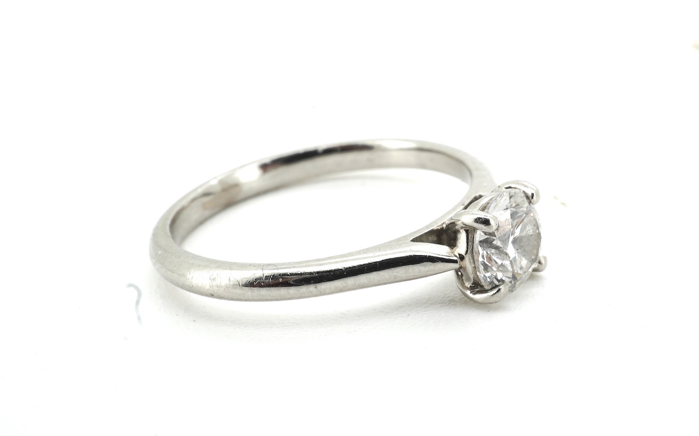 A diamond ring, claw-set with a brilliant-cut diamond weighing approximately 0.61 carats, mounted in platinum, size L, British hallmarks, gross weight approximately 3 grams